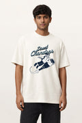 Man wearing an off-white oversized Direct Chandrar Goa graphic T-shirt with a moon-bound bottle illustration by Cult Style Goa.